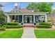 Charming blue home boasting a spacious front porch and a lush, green lawn at 933 N Highland Ne Ave, Atlanta, GA 30306