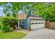 Detached garage featuring a carriage door and additional living space above, set in a well-maintained yard at 933 N Highland Ne Ave, Atlanta, GA 30306