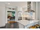 Modern white kitchen featuring stainless steel appliances and a view to the dining area at 933 N Highland Ne Ave, Atlanta, GA 30306