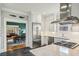 Bright kitchen with a marble island, stainless appliances, and view into dining area at 933 N Highland Ne Ave, Atlanta, GA 30306