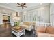 Bright living room with dark floors, shutters, and a view to kitchen and dining at 933 N Highland Ne Ave, Atlanta, GA 30306