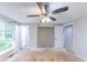 Bedroom featuring a ceiling fan, closet, and a window that offers natural light at 1060 S Millard Way, Stone Mountain, GA 30088