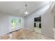 Empty dining room with french doors opening up to a deck and an open view of the kitchen at 1060 S Millard Way, Stone Mountain, GA 30088