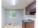 This kitchen features dark wood cabinets, gray countertop, and a window view at 1060 S Millard Way, Stone Mountain, GA 30088