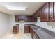 This kitchen features dark wood cabinets, countertops, and double sink at 1060 S Millard Way, Stone Mountain, GA 30088