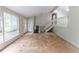 Empty living room with large windows, stairs and a white front door at 1060 S Millard Way, Stone Mountain, GA 30088