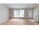 Empty living room with large windows and a white front door at 1060 S Millard Way, Stone Mountain, GA 30088