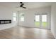 Bright, open living area with wood-look floors, and modern fireplace with access to outdoor space at 1510 Gatekeeper Ter, Marietta, GA 30066