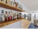 Rustic bar shelves in living room with kitchen view and hardwood floors at 1773 Kimberly Sw Dr, Marietta, GA 30008