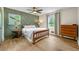 Well-lit bedroom featuring a decorative accent wall, hardwood floors, and natural light at 1773 Kimberly Sw Dr, Marietta, GA 30008