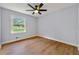 Bedroom features gleaming hardwood floors, neutral paint, updated fixtures and natural light at 1773 Kimberly Sw Dr, Marietta, GA 30008