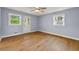 A serene light blue bedroom with a door to the outside and light-colored wood flooring at 1773 Kimberly Sw Dr, Marietta, GA 30008