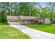 Charming brick and siding home with a well-manicured lawn and attached garage at 1773 Kimberly Sw Dr, Marietta, GA 30008