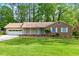 Charming single-story home with a well-maintained lawn, inviting front porch, and an attached garage at 1773 Kimberly Sw Dr, Marietta, GA 30008