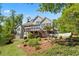 Backyard with the lawn, landscaping, back deck, and decorative yard fowl at 922 Florence Rd, Douglasville, GA 30134