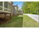 Backyard view of the lawn and white picket fence at 922 Florence Rd, Douglasville, GA 30134