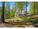 Expansive backyard featuring a screened porch, deck, and a tiered yard with mature trees and lush greenery at 922 Florence Rd, Douglasville, GA 30134