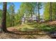 Backyard view of the home with lawn, woods, screen porch and back deck at 922 Florence Rd, Douglasville, GA 30134
