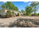 Large outbuilding barn with multiple garage doors and ample gravel parking at 922 Florence Rd, Douglasville, GA 30134