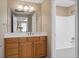 Bathroom featuring a single sink vanity with wood cabinets and white countertops and a shower/tub combo at 922 Florence Rd, Douglasville, GA 30134