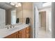 Bathroom with a single sink vanity, a large mirror, and a view into another room at 922 Florence Rd, Douglasville, GA 30134