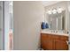 Bathroom with wood cabinets, white countertops, and a large mirror, creating a functional space at 922 Florence Rd, Douglasville, GA 30134