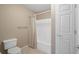Bright bathroom featuring a toilet, shower and door at 922 Florence Rd, Douglasville, GA 30134