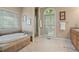 Bathroom featuring a soaking tub and a glass-enclosed shower at 922 Florence Rd, Douglasville, GA 30134
