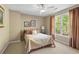 Cozy bedroom with natural light, a patterned quilt, and striped curtains at 922 Florence Rd, Douglasville, GA 30134