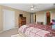 Bedroom with neutral walls, a ceiling fan, large windows, and a cozy bed for a peaceful retreat at 922 Florence Rd, Douglasville, GA 30134