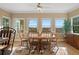 Bright dining area with a round table, wood chairs, and scenic views through large windows at 922 Florence Rd, Douglasville, GA 30134