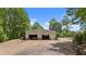 Large metal outbuilding with parking and storage, set against a scenic wooded backdrop at 922 Florence Rd, Douglasville, GA 30134