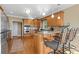 Kitchen features a breakfast bar with stools, wooden cabinets, stainless appliances, and hardwood floors at 922 Florence Rd, Douglasville, GA 30134