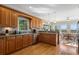 Well-lit kitchen with wood cabinets, stainless steel appliances, and hardwood flooring at 922 Florence Rd, Douglasville, GA 30134
