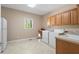 Functional laundry room with a utility sink, window and plenty of storage space at 922 Florence Rd, Douglasville, GA 30134
