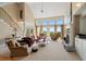 Bright living room with fireplace, high ceilings, and large windows showcasing outdoor views at 922 Florence Rd, Douglasville, GA 30134