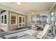 Relaxing sunroom with ceiling fans, ample seating, and scenic views through large windows at 922 Florence Rd, Douglasville, GA 30134