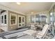 Relaxing sunroom features ceiling fans, lounge chair, and an outdoor dining table with views of the property at 922 Florence Rd, Douglasville, GA 30134