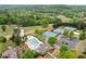 Aerial view of the community pool and tennis courts, surrounded by lush green landscape at 1039 Avery Creek Dr, Woodstock, GA 30188