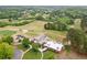 Aerial view of a red barn-style clubhouse with a golf course in the background at 1039 Avery Creek Dr, Woodstock, GA 30188