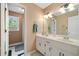 Bathroom features double sinks, a mirror, a shower, a toilet and a window with a view at 1039 Avery Creek Dr, Woodstock, GA 30188
