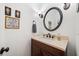Stylish half bathroom featuring updated vanity with black faucet and decor at 1039 Avery Creek Dr, Woodstock, GA 30188