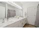 Bathroom features double sinks, marble countertops, vanity mirrors, and a neutral color palette at 1039 Avery Creek Dr, Woodstock, GA 30188