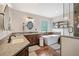 A stylish primary bathroom with double vanities, a soaking tub, and glass enclosed shower at 1039 Avery Creek Dr, Woodstock, GA 30188