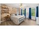 Bedroom features an accent wall, ceiling fan, windows with blue curtains, and hardwood floors at 1039 Avery Creek Dr, Woodstock, GA 30188