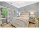 A serene bedroom with plush bedding, mirrored nightstands, and soft lighting, creating a relaxing and inviting atmosphere at 1039 Avery Creek Dr, Woodstock, GA 30188