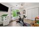 Bedroom features a treadmill, television, window with a view and a closet at 1039 Avery Creek Dr, Woodstock, GA 30188