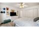 Bedroom features a bed, dresser with a tv, closet and decorated walls with hats at 1039 Avery Creek Dr, Woodstock, GA 30188