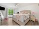 Bedroom features a large bed, night stand and a window with a view at 1039 Avery Creek Dr, Woodstock, GA 30188