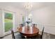 Formal dining room featuring a decorative light fixture and front yard view at 1039 Avery Creek Dr, Woodstock, GA 30188